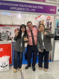 Zhongshan Youya'an Electric Appliance (UCK) team with a B2B client at their food dehydrator manufacturer booth during IEAE Russia.